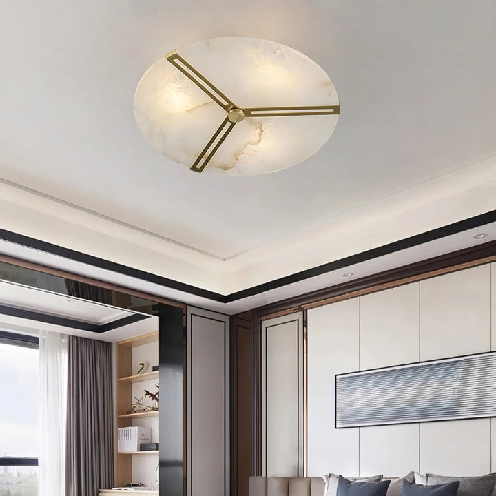 Bottom view of alabaster clock ceiling light with natural veining and brass accents, modern décor