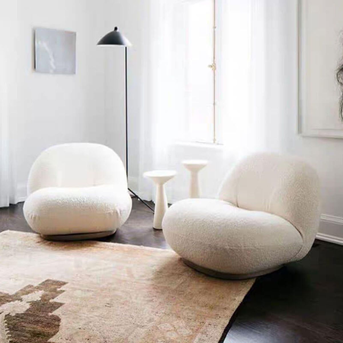 Cloud swivel lounge chair in living room setting with modern decor and cozy ambiance