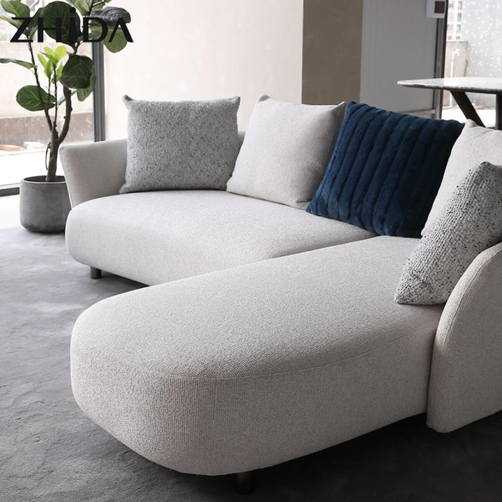Front angle view of Coastal Curve sofa lounge showcasing plush cushions and elegant curved design.