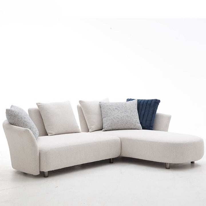 Side view of Coastal Curve sofa lounge highlighting its smooth curved frame and plush cushions.