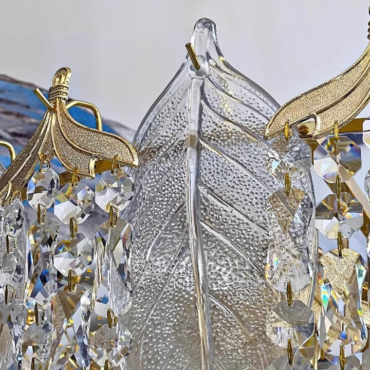 Close-up detail view of crystal leaf chandelier light, highlighting sparkling leaf-shaped crystals and exquisite craftsmanship.