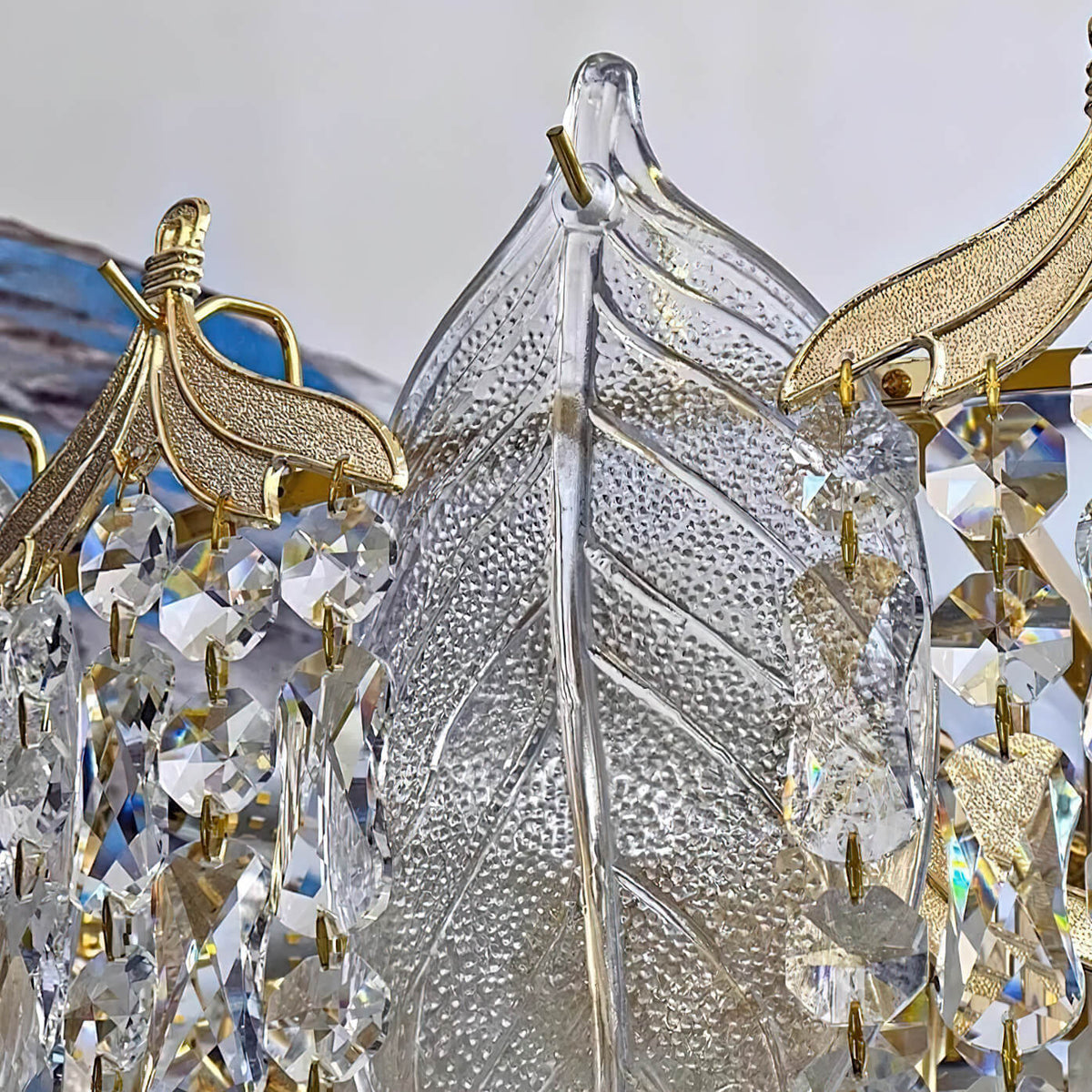 Close-up detail view of crystal leaf chandelier light, highlighting sparkling leaf-shaped crystals and exquisite craftsmanship.