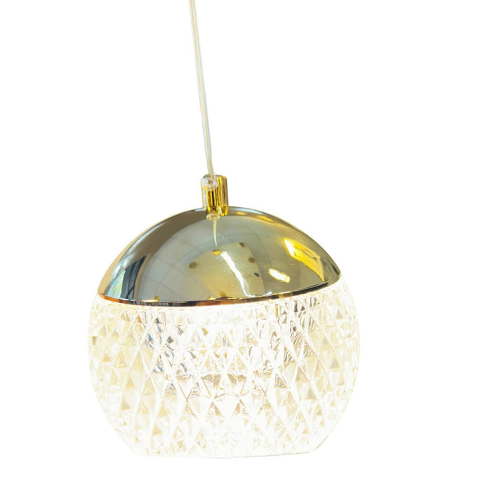 Top view of crystal prism pendant light with gold finish and LED bulb, showcasing detailed craftsmanship and geometric design