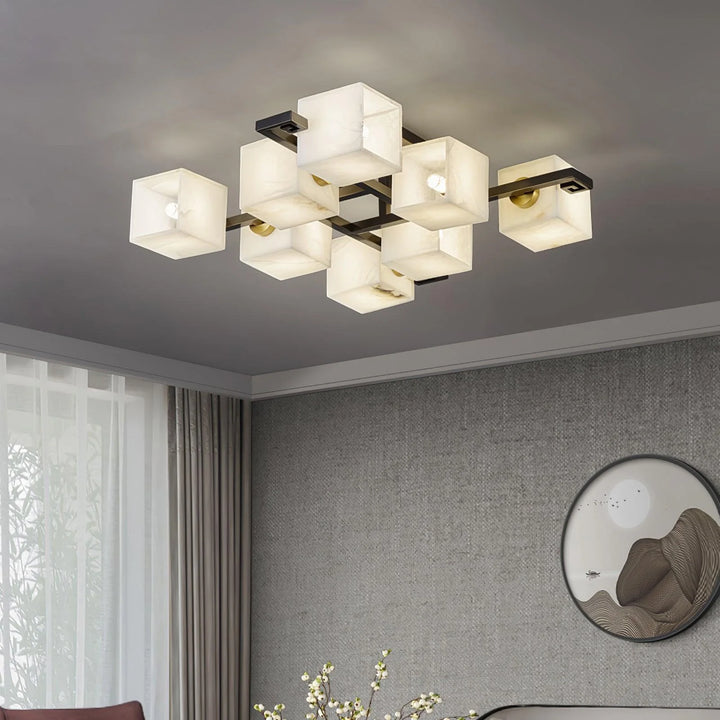 Front view of Cubist Alabaster Cluster ceiling lamp on square marble, turned on