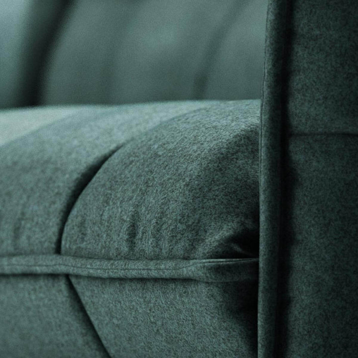 Detailed shot of AeroLuxe custom sofa fabric texture and craftsmanship in green linen