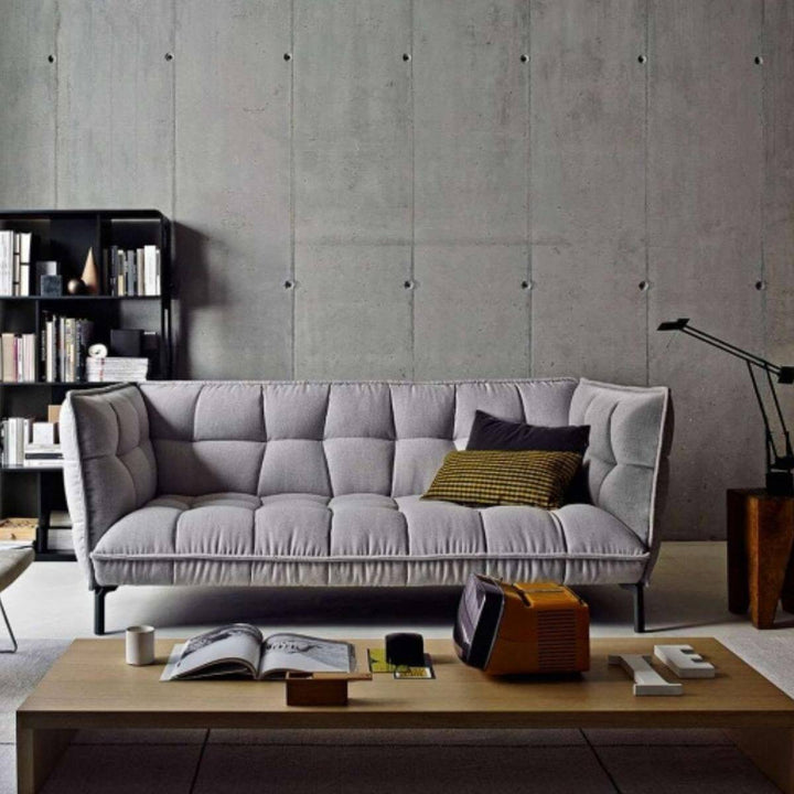 Custom AeroLuxe sofa upholstered in gray linen fabric, angled view showing modern design