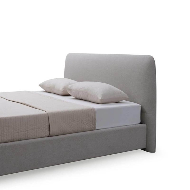 Side view of Elegant Ergo wooden frame cotton linen bed showcasing natural wood grain and soft fabric