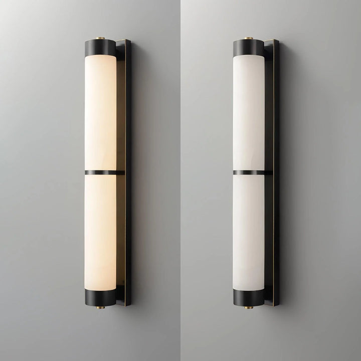 Cylindra alabaster brass wall light with black finish shown from front view in modern elegant interior