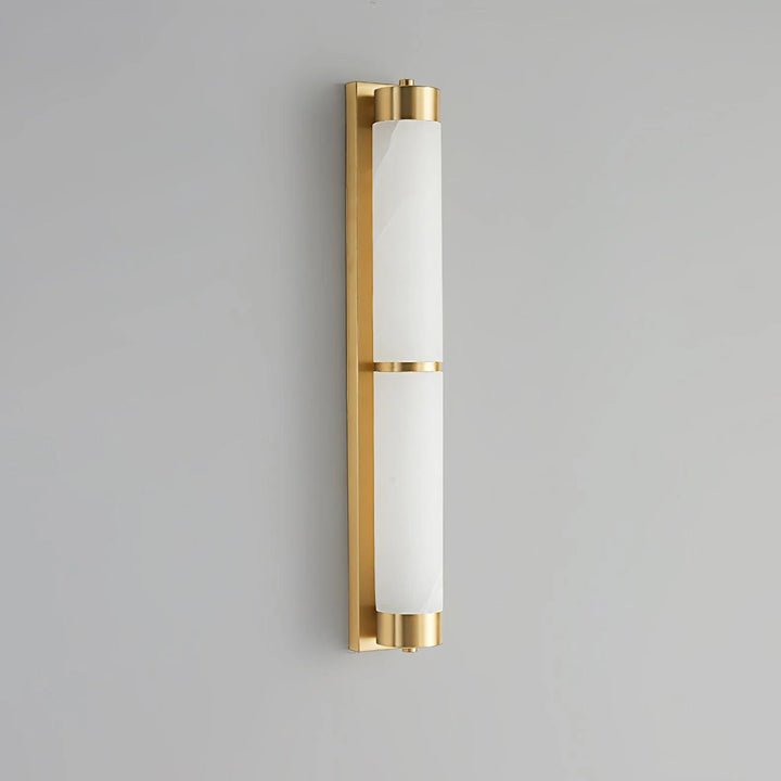 Cylindra alabaster brass wall light with golden mount shown from angle view, highlighting elegant modern design
