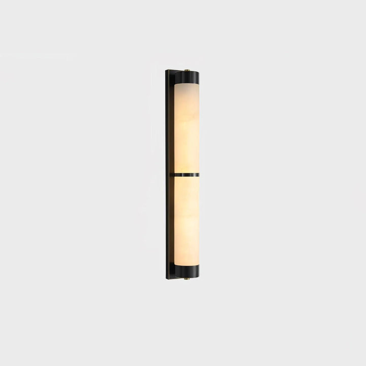 Cylindra alabaster brass wall light with black wall mount shown from side view in modern elegant interior