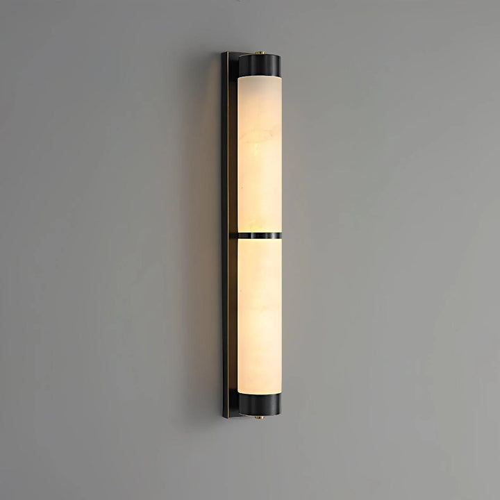 Cylindra alabaster brass wall light with black wall mount shown from side view in sleek modern interior