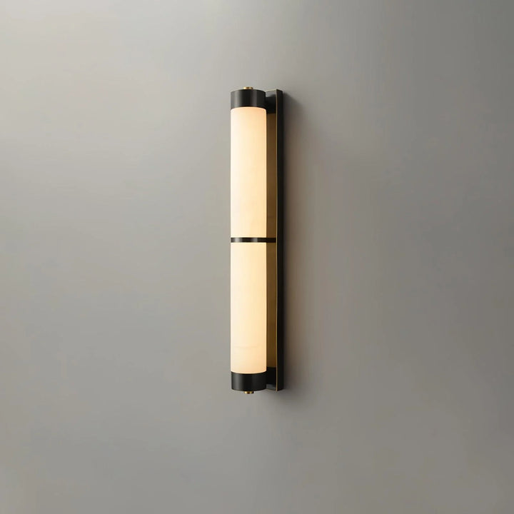 Cylindra alabaster brass wall light shown from front side view, highlighting sleek modern design in interior setting