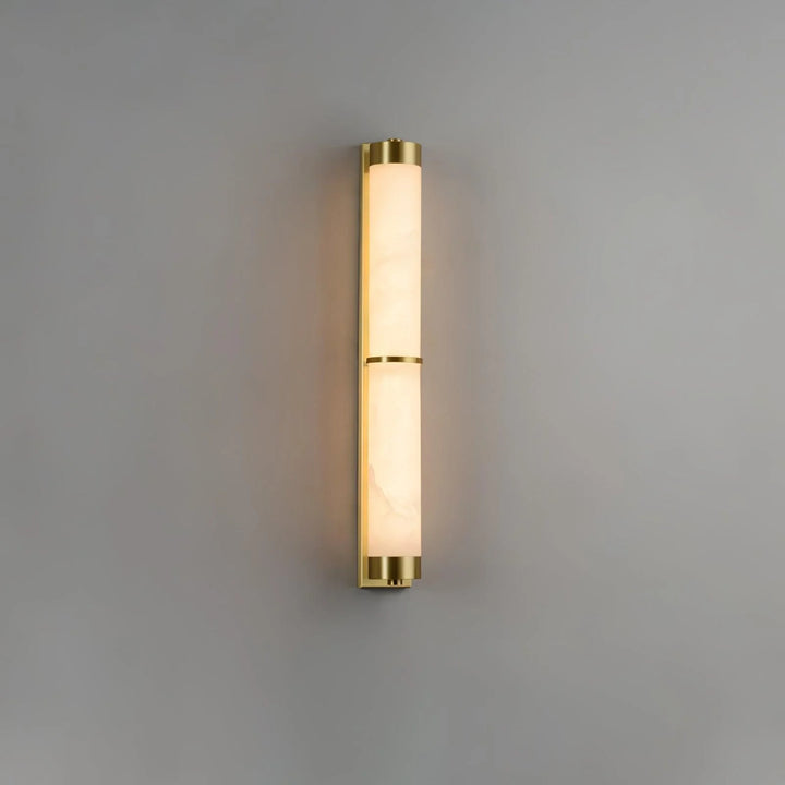 Cylindra alabaster brass wall light shown from side view, highlighting sleek modern design in stylish interior
