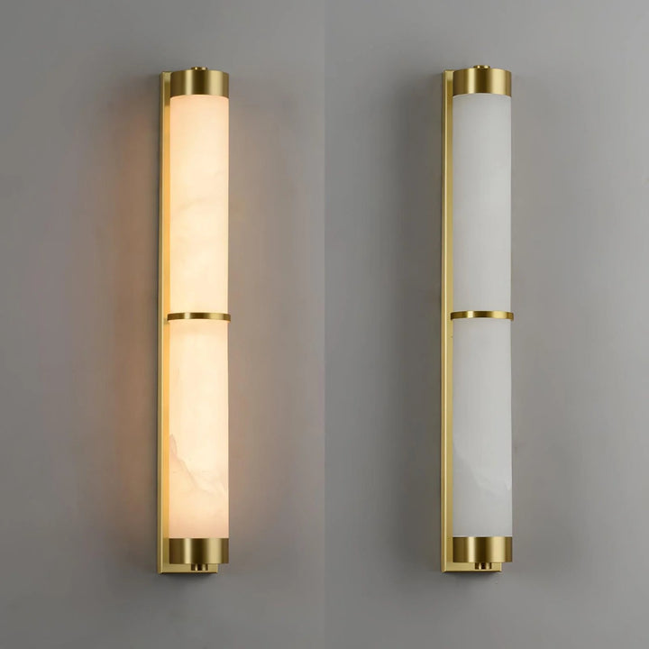Cylindra alabaster brass wall light with gold finish illuminated, shown from side view in modern elegant interior