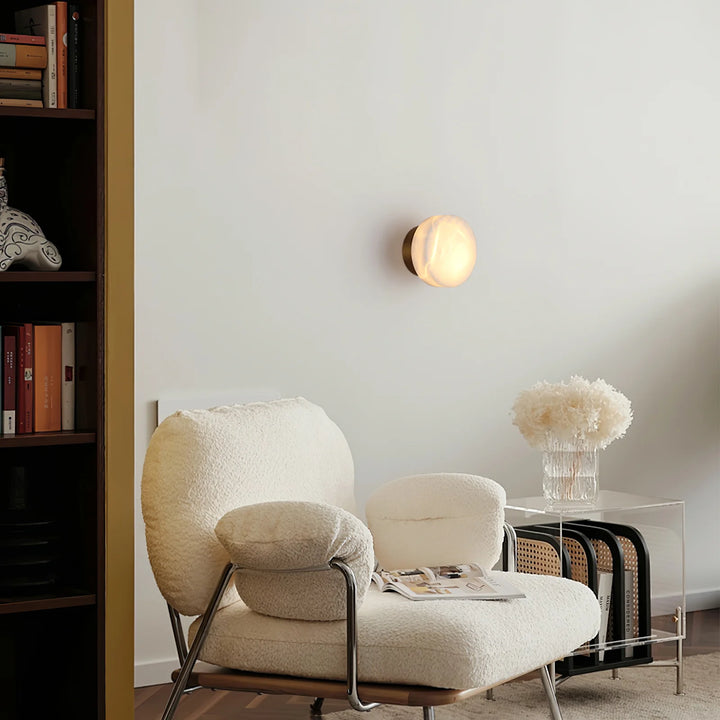 Cylindrical alabaster wall light mounted on living room wall for modern home décor