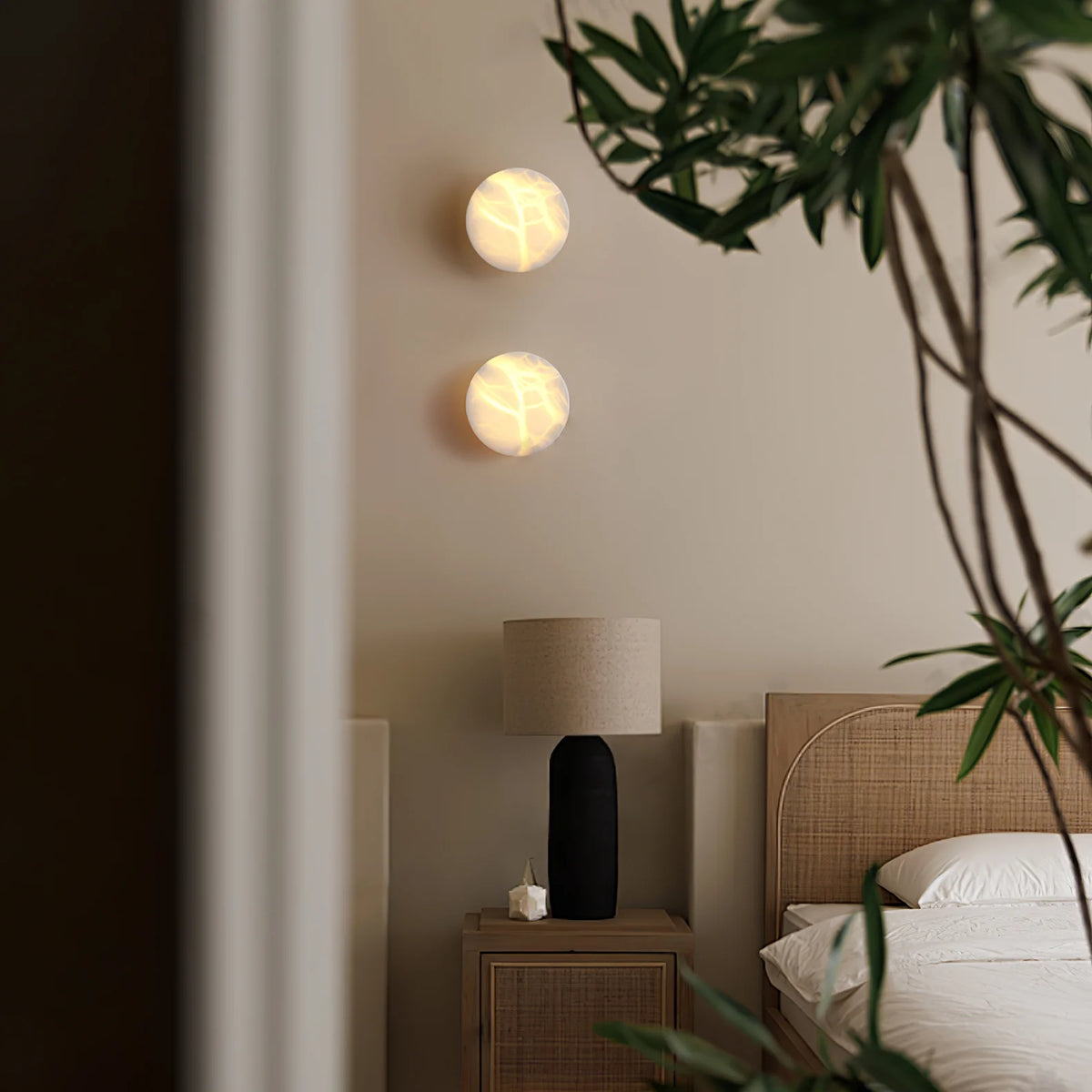 Bedside wall view of cylindrical alabaster wall light for modern bedroom lighting décor