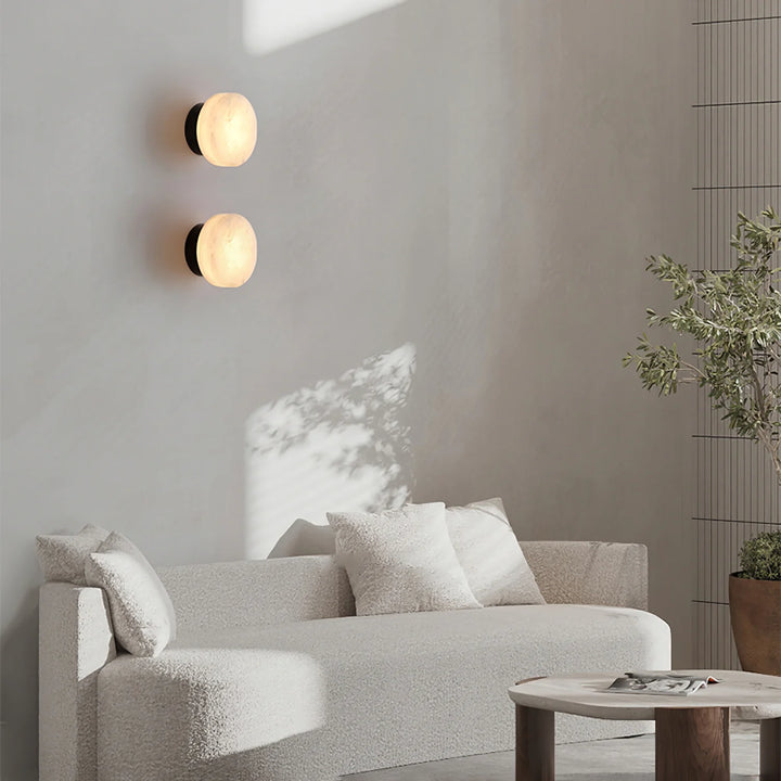 Cylindrical alabaster wall light on living room wall for modern and elegant home décor