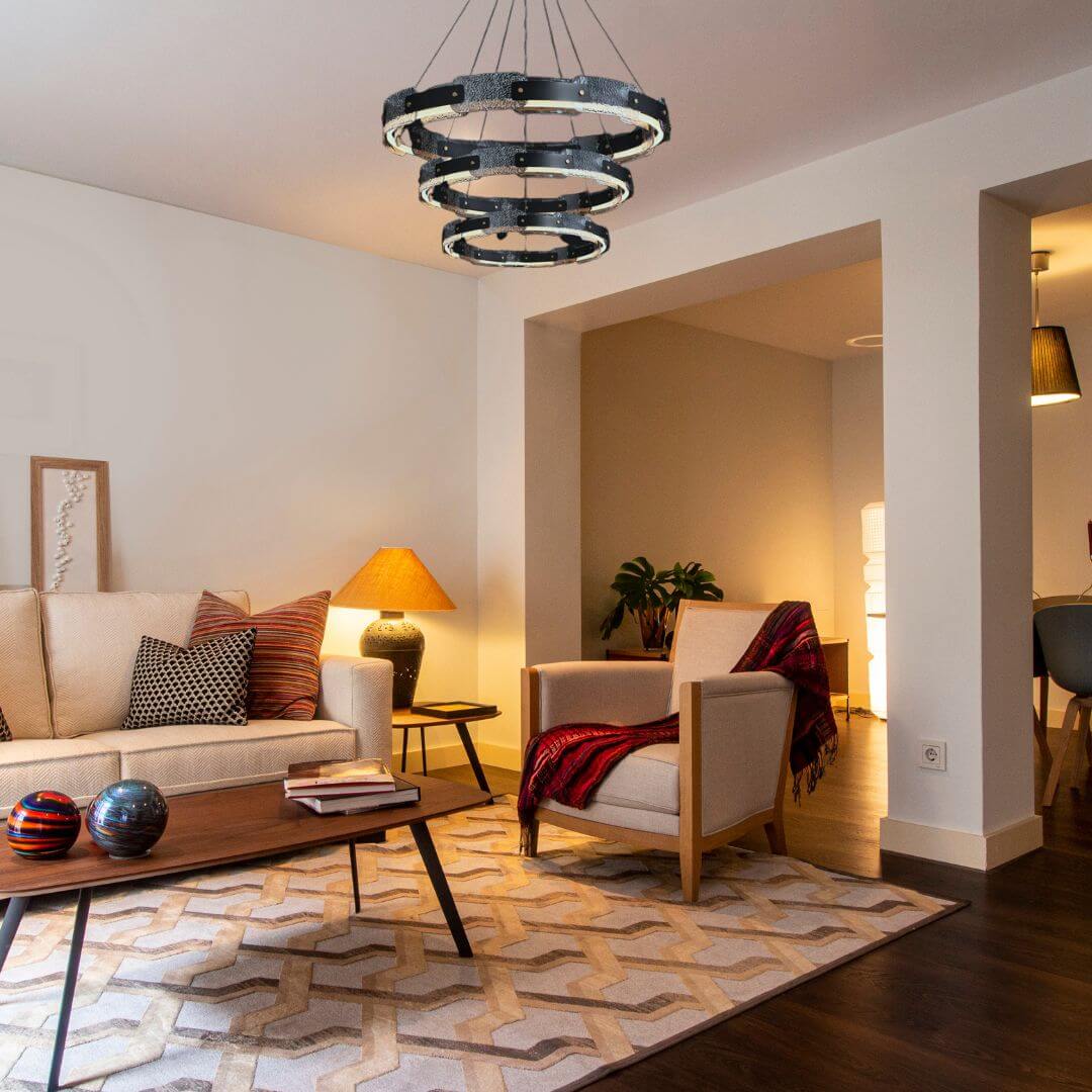 Dazzle three-tier chandelier light turned on in luxury living room, creating a stunning and elegant focal point with sparkling crystals