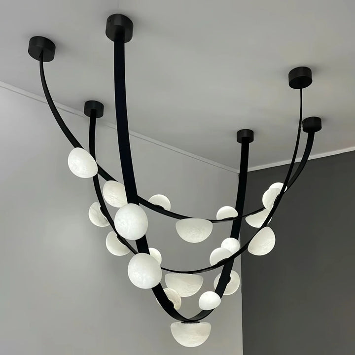 Three-layer hanging view of Dew Drops Alabaster chandelier in modern interior