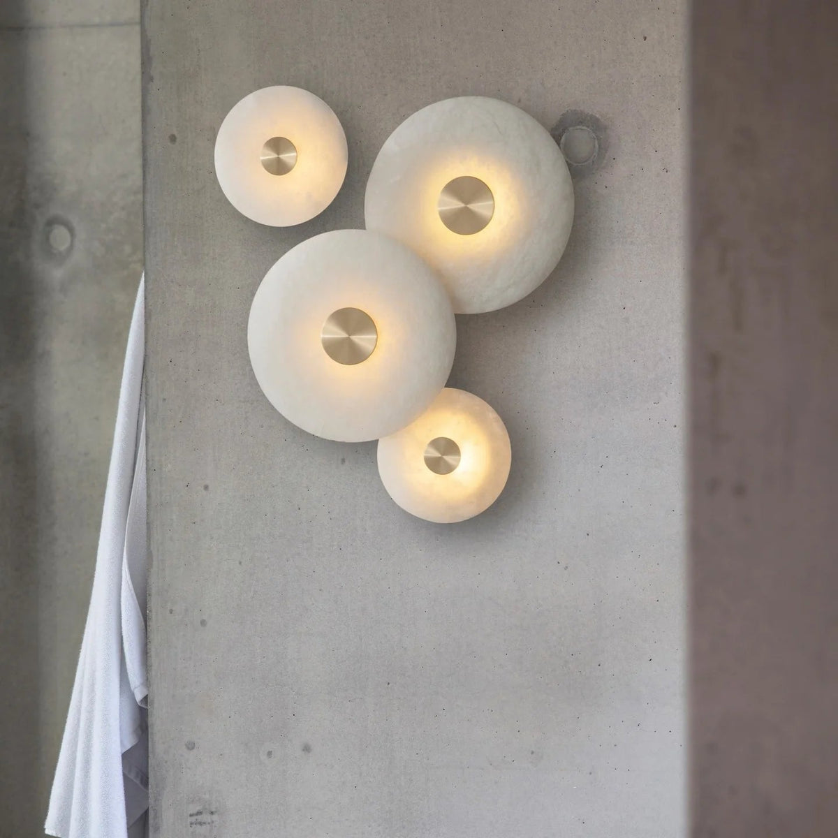 Disc-shaped alabaster wall light lamp, front view, elegant modern interior home lighting