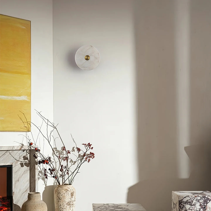 Disc-shaped alabaster wall light on living room wall, elegant modern interior lighting decor