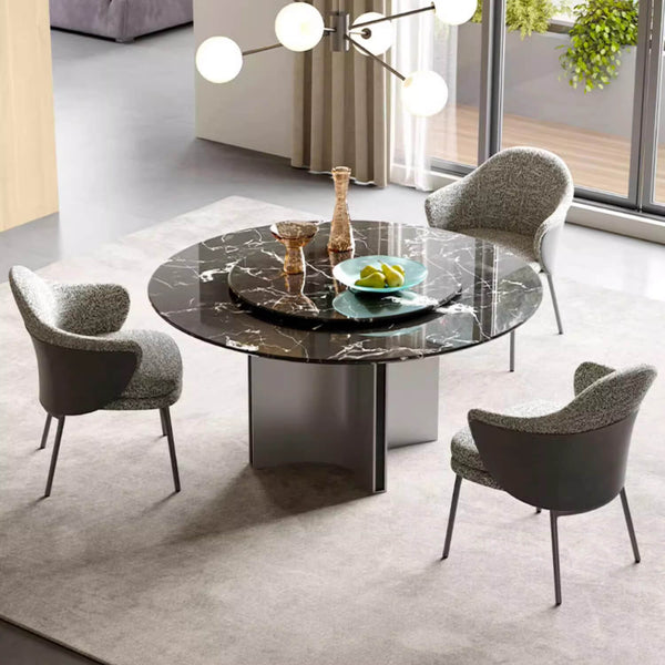 Elegant round dining table with custom stone top and sleek base, perfect for modern and sophisticated dining spaces
