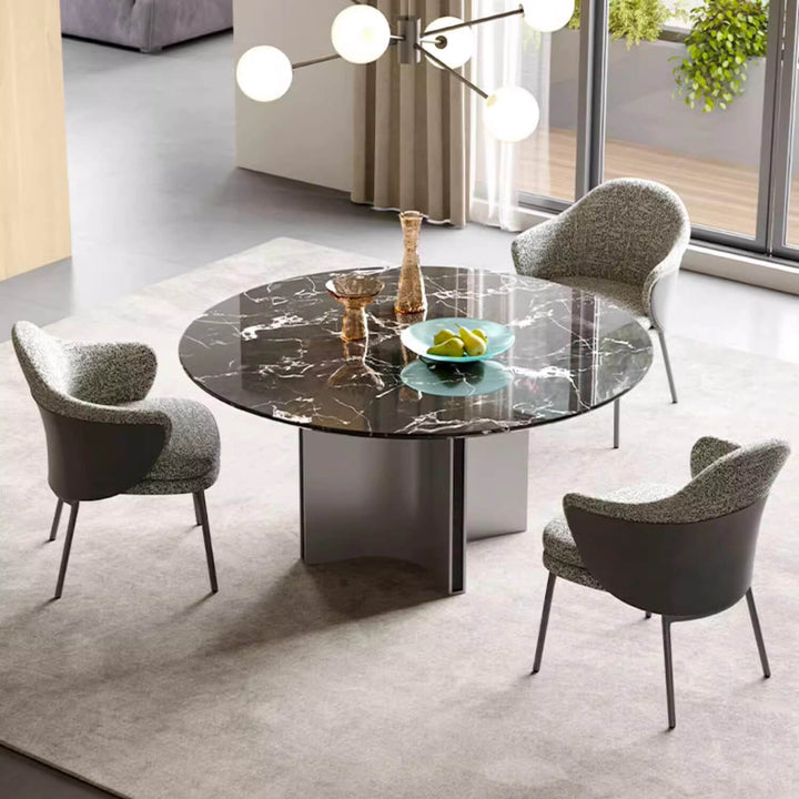Elegant round dining table with custom natural stone top featuring soft colors and visual balance, supported by brushed metal feet for a luxurious and artistic look