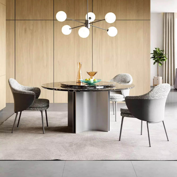 Elegant round dining table with smooth steel finish and minimalist design, perfect for modern interior settings