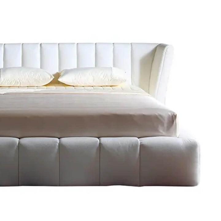half front view of Ferrara bed showcasing upholstered headboard and sleek frame with modern design