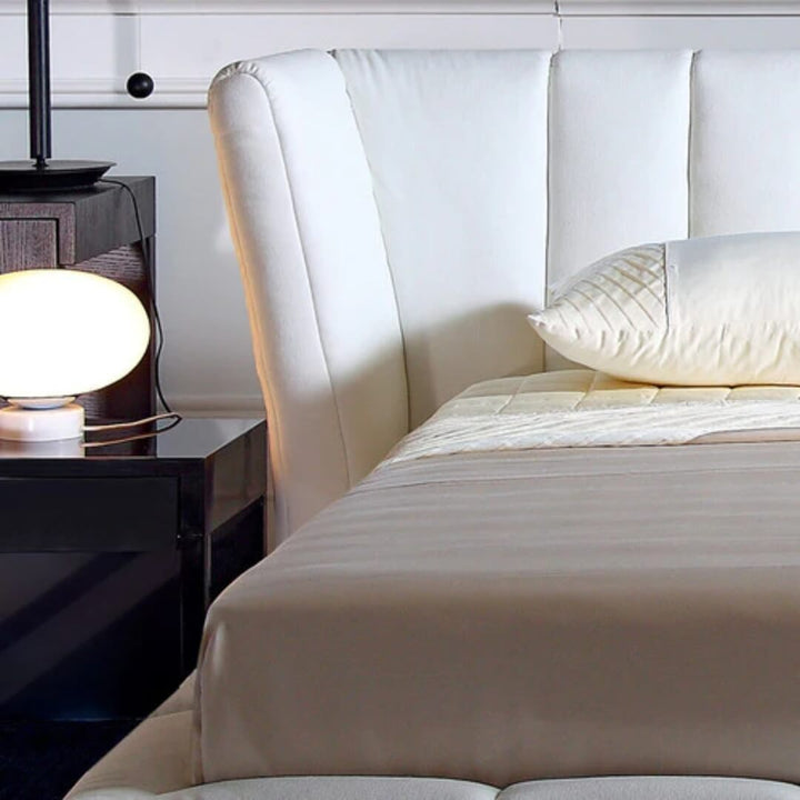 Front view of Ferrara bed highlighting plush upholstered headboard and sleek frame design