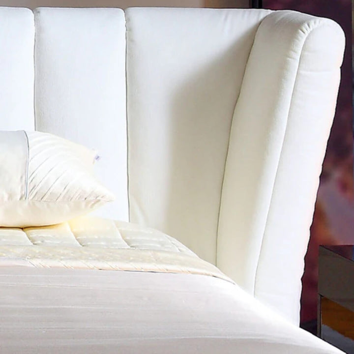 Side view of Ferrara bed showcasing upholstered headboard and sleek frame with modern design