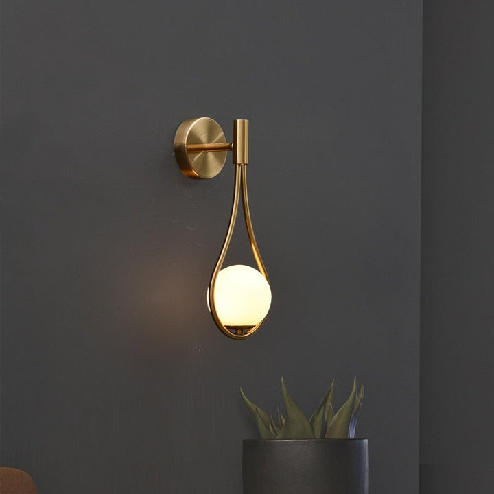 Fleuren teardrop wall light illuminated with warm glow, enhancing the elegance and coziness of modern interior spaces