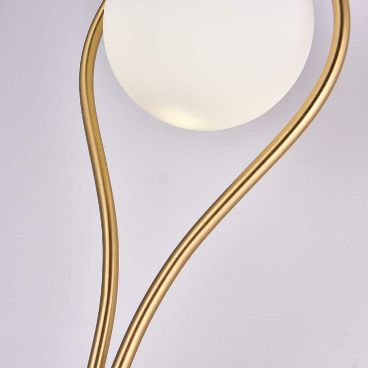 Fleuren teardrop wall light with curved copper fixture, offering warm ambient lighting and adding sophisticated charm to elegant interiors