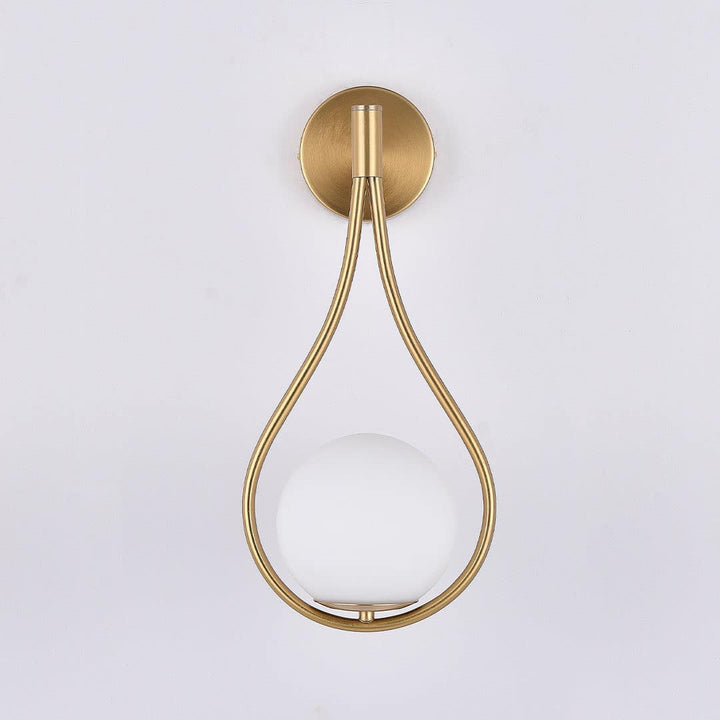 Fleuren teardrop wall light with sleek curved design, casting a warm ambient glow in an elegant interior setting