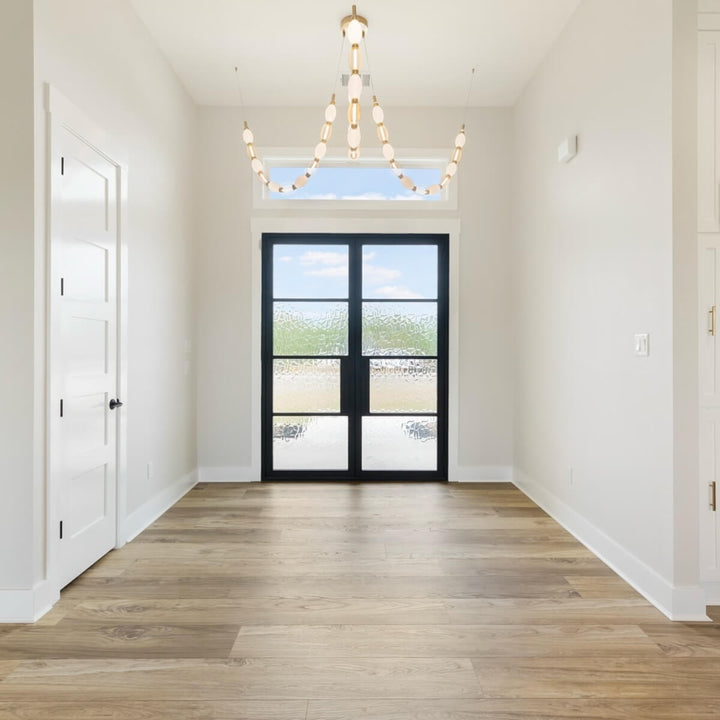 Florent 3-lamp adjustable LED chandelier in aged gold installed at entry gate – elegant lighting with modern adjustable arms.