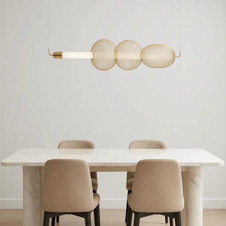 Modern dining room with a white table, beige chairs, and a stylish pendant light.