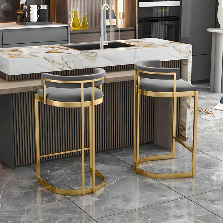Glam bar stool back view – upholstered with gold base.