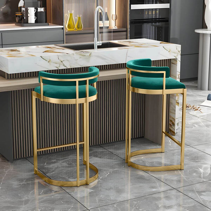 Glam bar stool back view – upholstered with gold base.