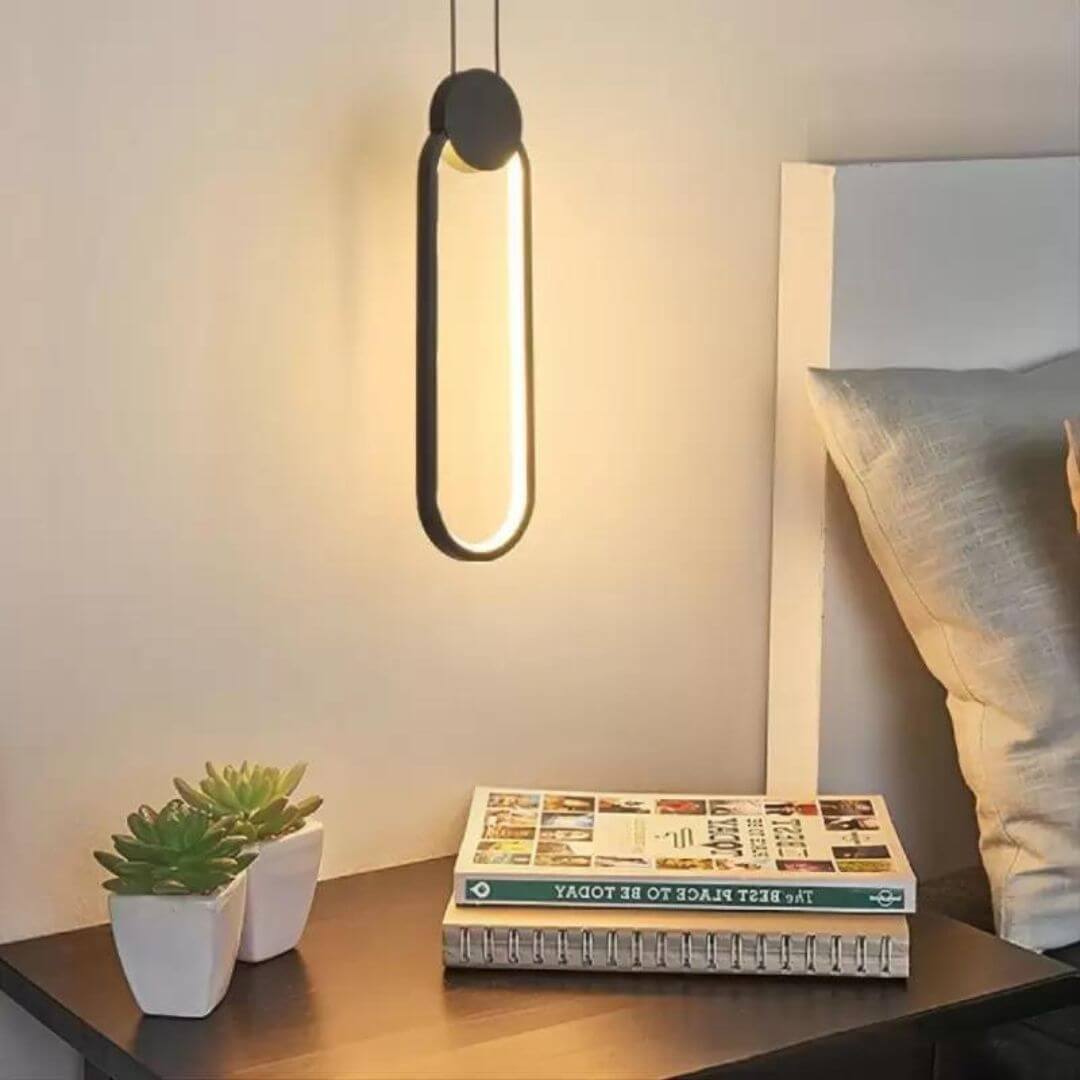 Glow Oval-Shaped Pendant Light Hanging Above Bedside Table – Elegant Bedroom Lighting