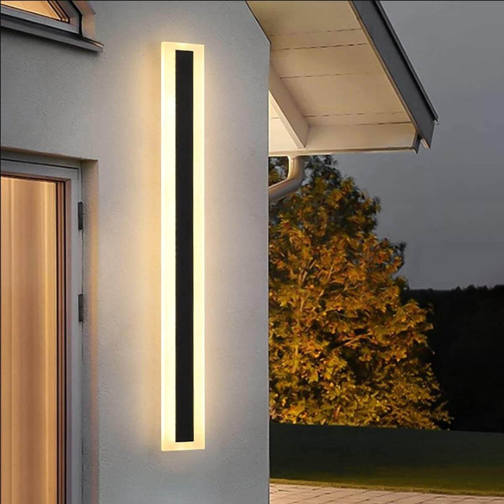 GlowEdge linear modern outdoor wall light illuminated in the evening – sleek and stylish lighting enhancing outdoor ambiance.