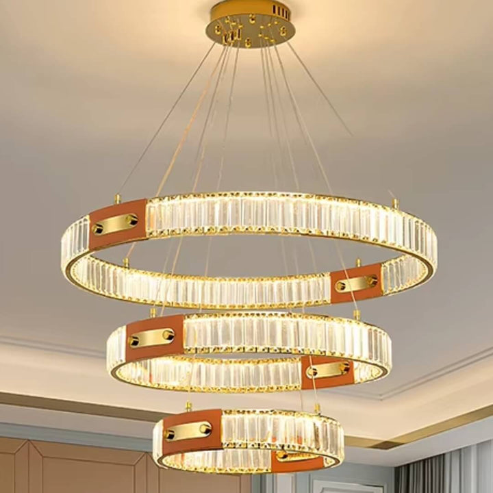 Close front view of gold crystal chandelier with three interlocking rings, showcasing sparkling crystals and elegant design