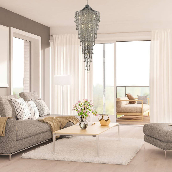 Illusion crystal chandelier hanging above staircase in living room, creating a stunning and elegant focal point