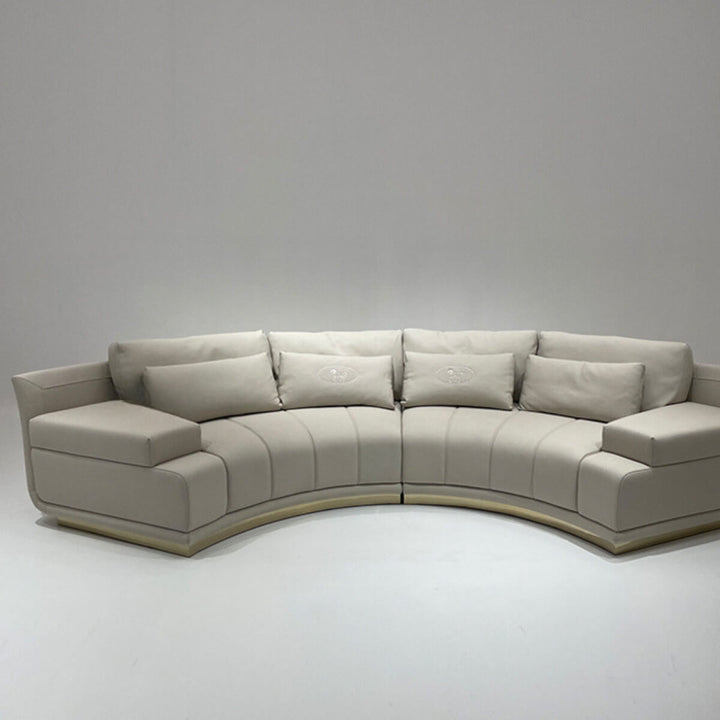 Front view of infinity curved leather sofa in elegant interior, showcasing modern and stylish seating