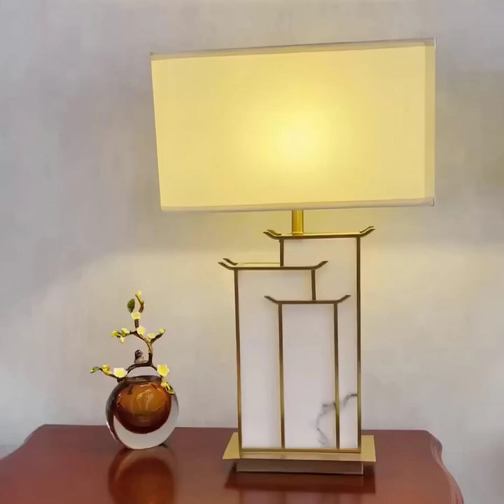 Front view of July table lamp, featuring modern sleek design with warm ambient lighting for interiors