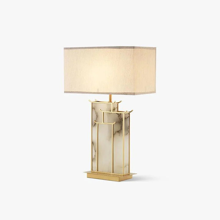 Side angle view of modern July table lamp with gold leaf metal, alabaster base, and LED light