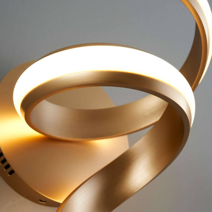 Close-up detail of Lara golden spiral LED wall sconce light by Lux Decor Australia