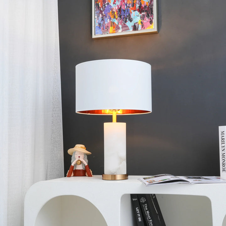 Front view of Lineham table lamp with alabaster base, brass accents, and linen drum shade