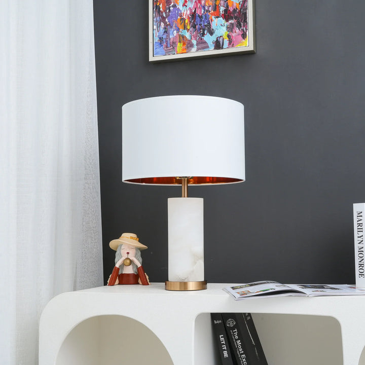 Front view of Lineham table lamp with alabaster base, brass accents, and linen drum shade