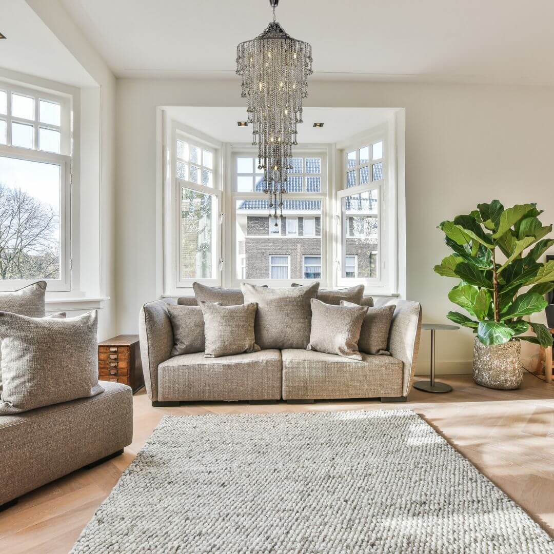 Illusion crystal chandelier hanging above staircase in living room, creating a stunning and elegant focal point