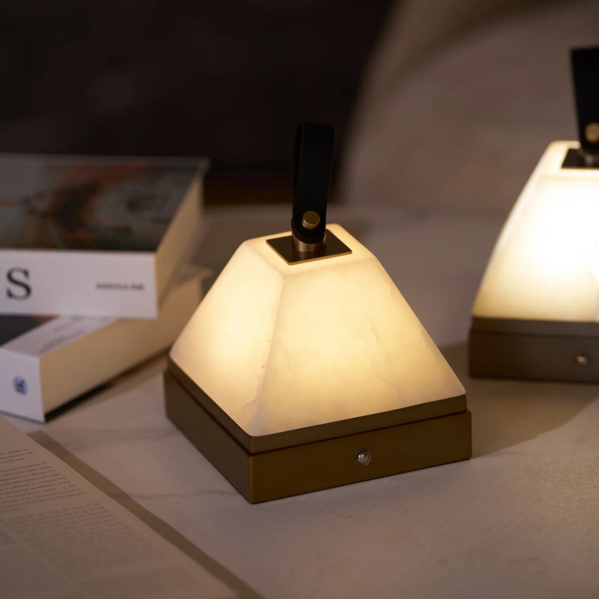 Luma cube portable lamp side view featuring sleek cube design with warm glow, compact rechargeable light